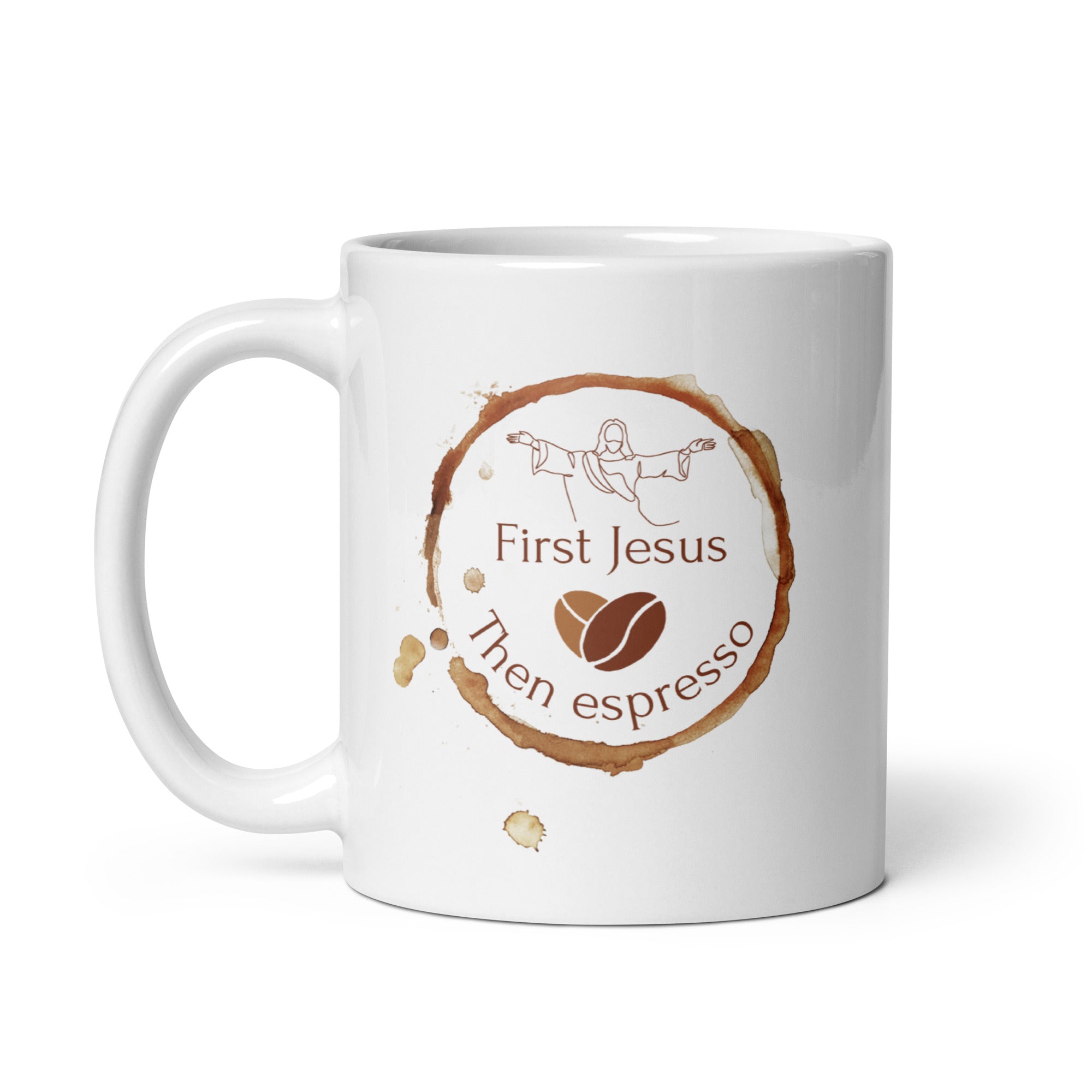A white coffee mug with a brown coffee ring stain design that reads 'First Jesus Then Espresso', featuring an illustration of Jesus and coffee beans.