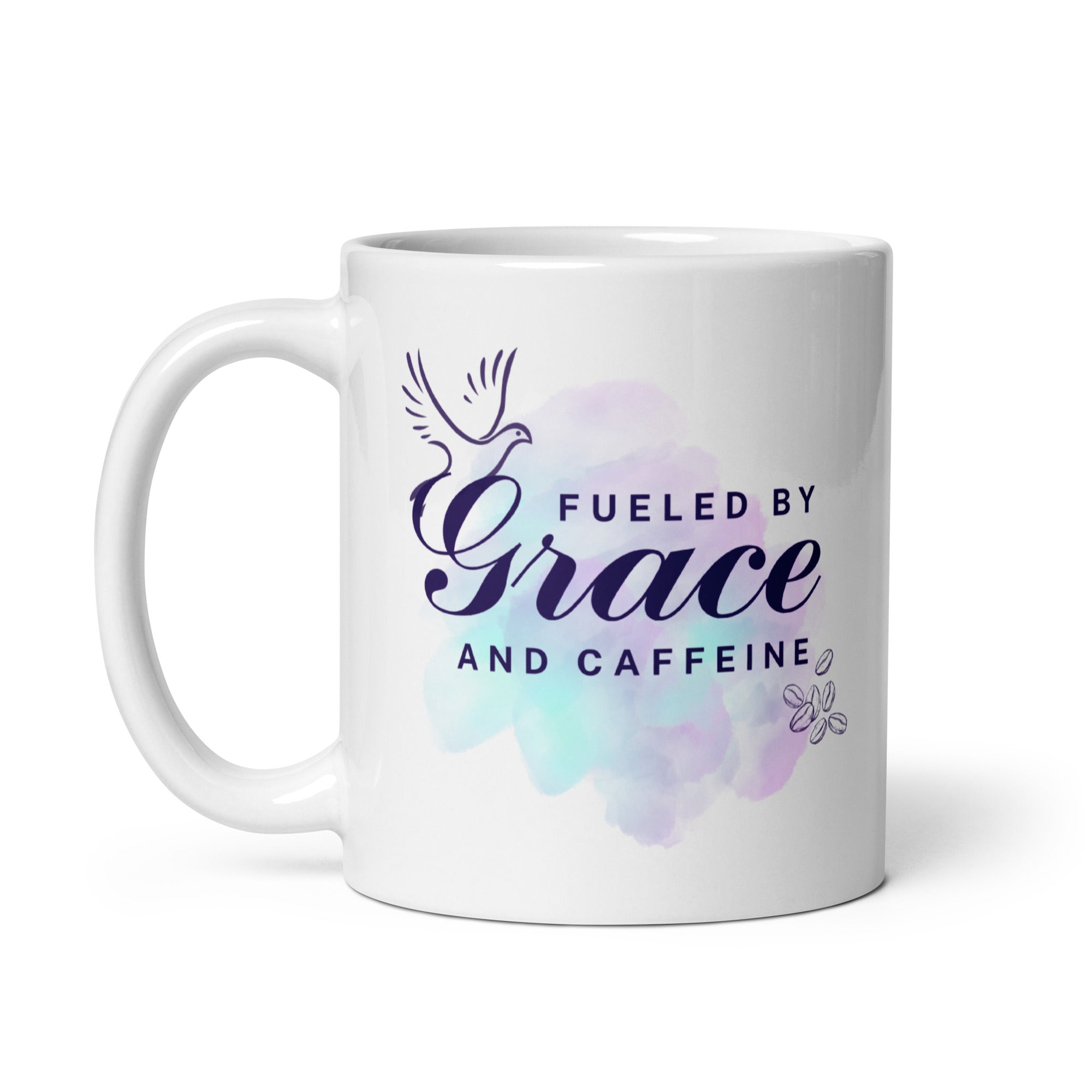 A white coffee mug with a purple watercolor design that reads 'Fueled by Grace and Caffeine', featuring a dove and coffee beans.